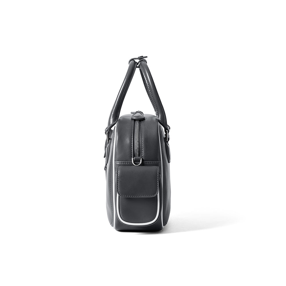 Side view of sleek black leather bag with zipper and front pocket, Amazing Song official website
