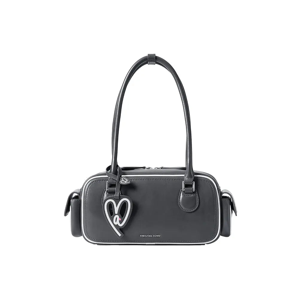 Amazing Song black handbag with heart keychain and double handles on white background