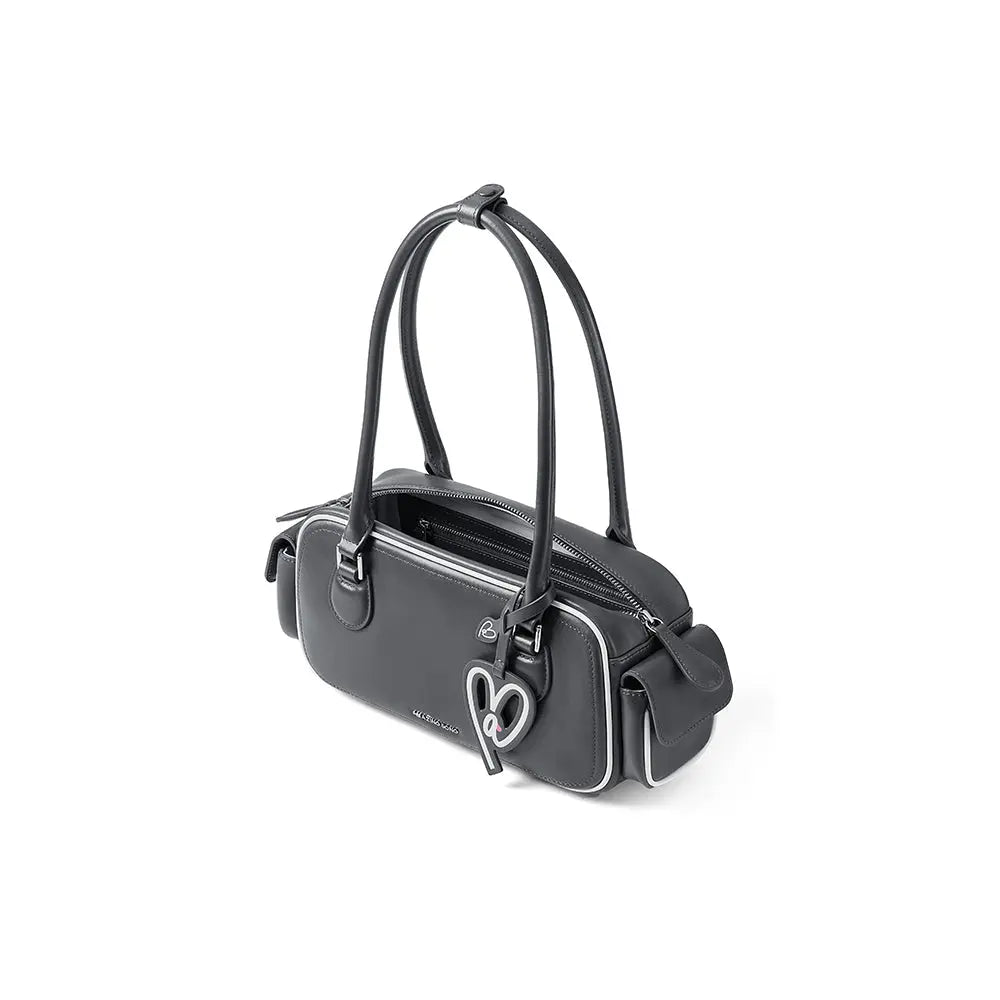 Black Amazing Song handbag with double straps, heart charm, and white trim on white background