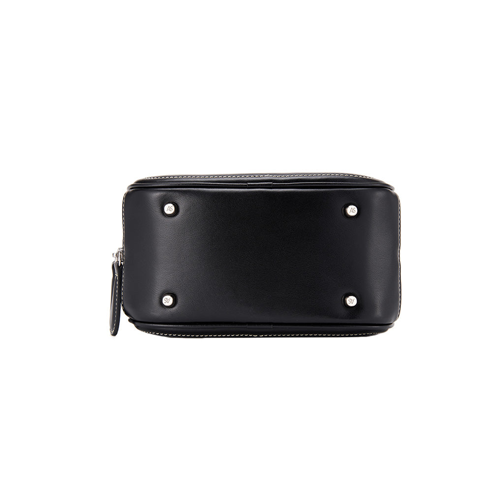 Bottom view of black leather Amazing Song bag with silver metal feet and zipper detail