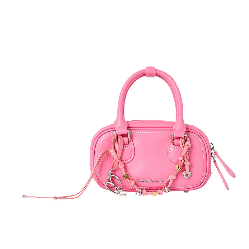 Amazing Song pink handbag with braided strap and metallic heart charm